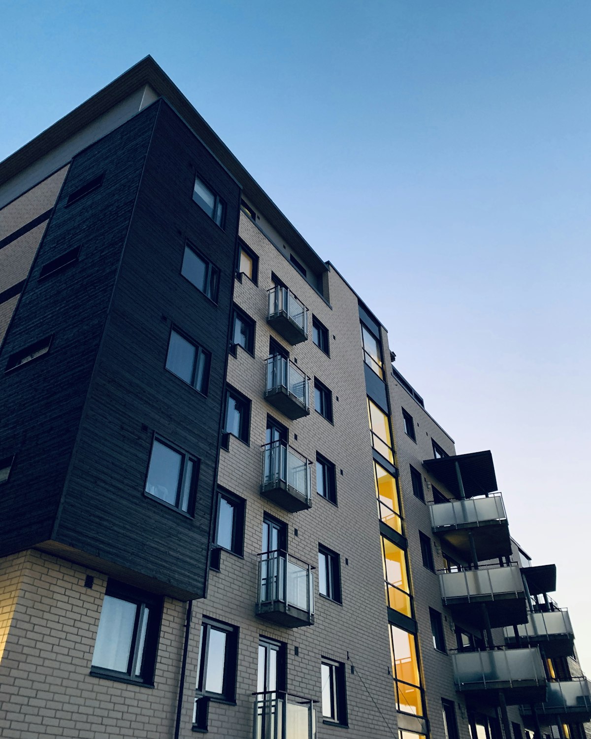 Mid-rise apartment building with balconies at dusk